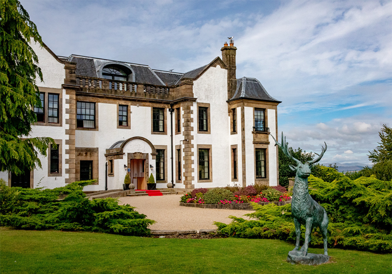 Gleddoch exterior with deer statue in foreground